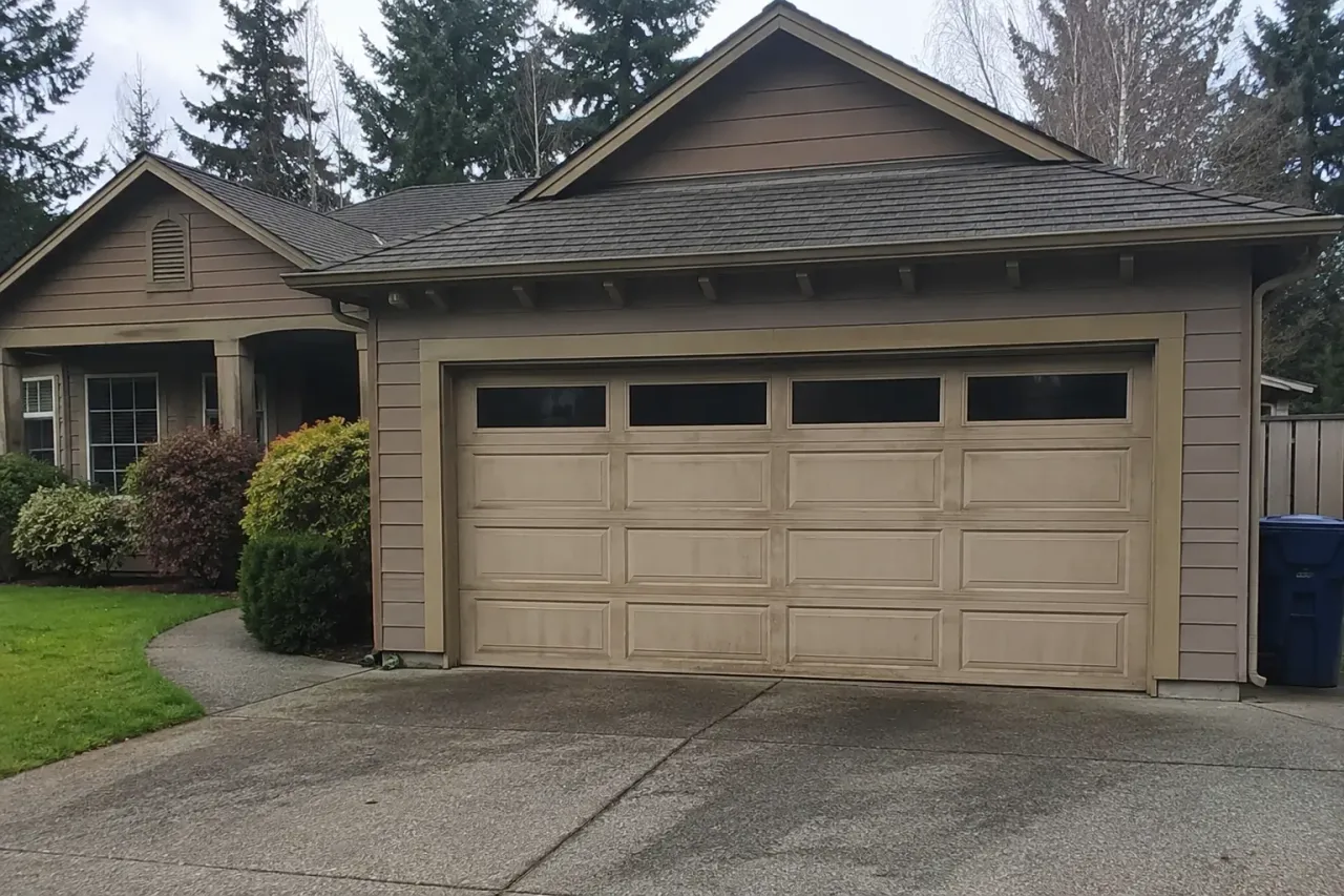 Old garage door on a Bellevue, WA home before Boost Garage Doors replaced it.