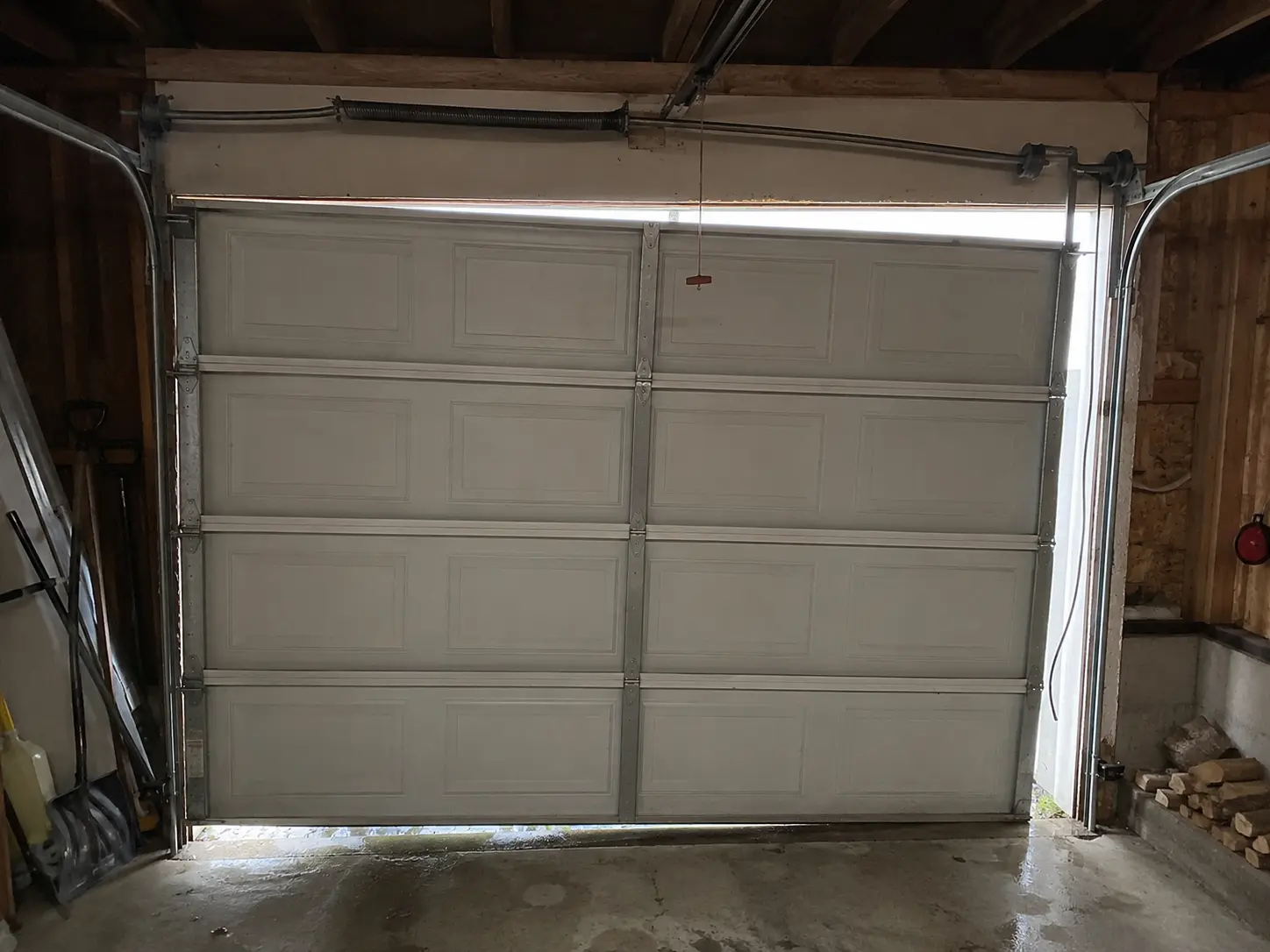 Snapped garage door lift cable on an Olympia, WA door before Boost Garage Doors repaired it.