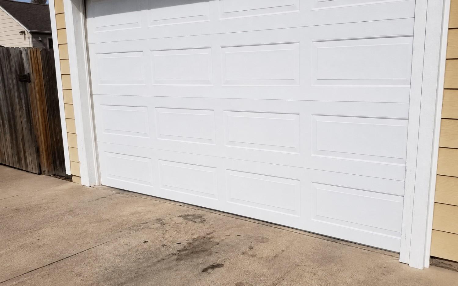 A clean new bottom panel matched to the rest of the door, replaced by Boost Garage Doors.