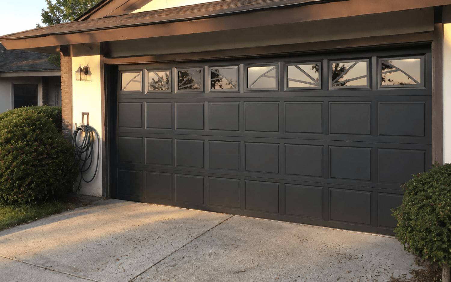 A brand new modern garage door on the same home, installed by Boost Garage Doors.