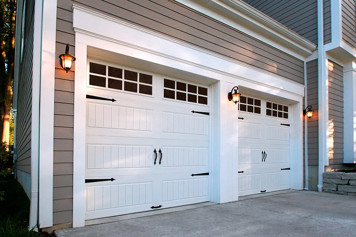 New white carriage style double garage door on a home exterior.