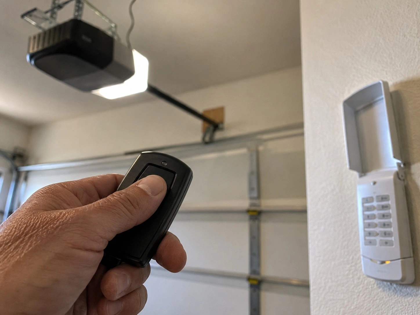 Remote and entry keypad being programmed after a new garage door install.