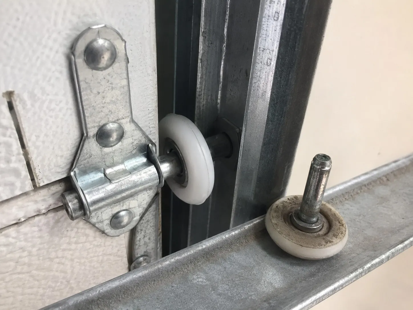 New nylon garage door roller seated in the track.
