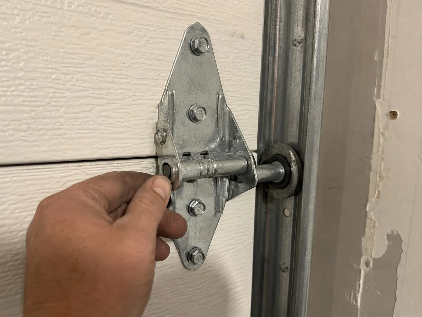 Hinge joining two garage door sections.