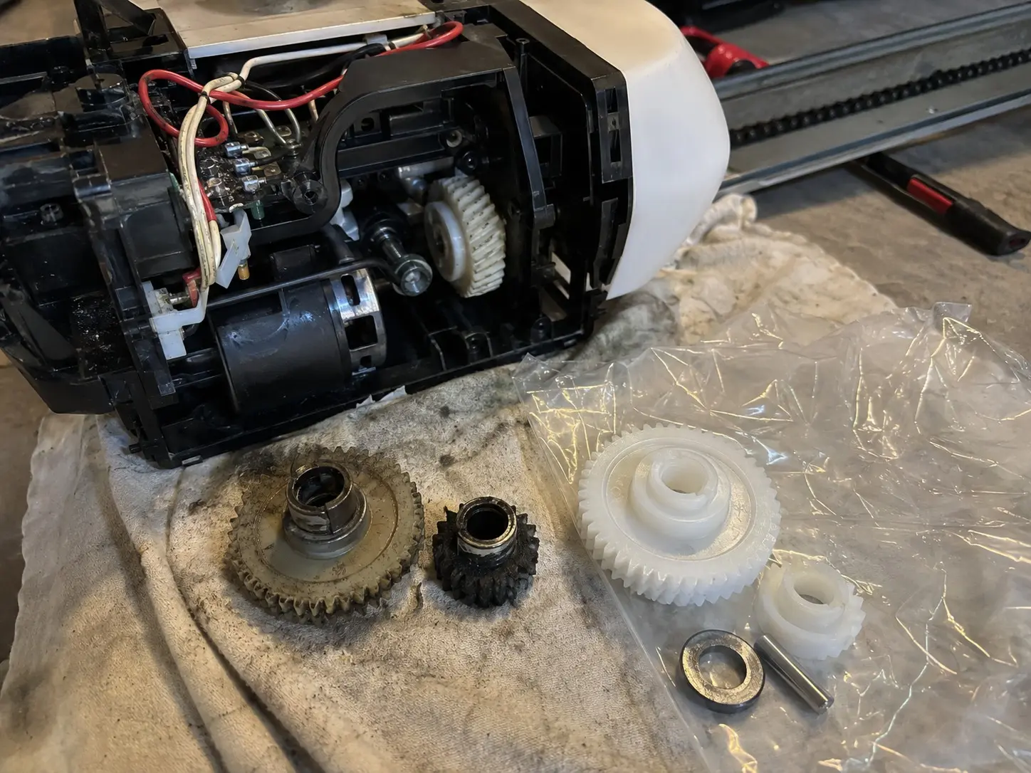 Worn plastic drive gear and sprocket from a garage door opener.