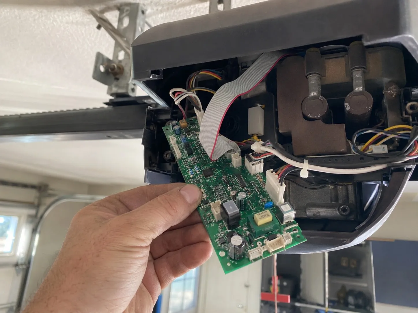 Garage door opener logic board removed for replacement.