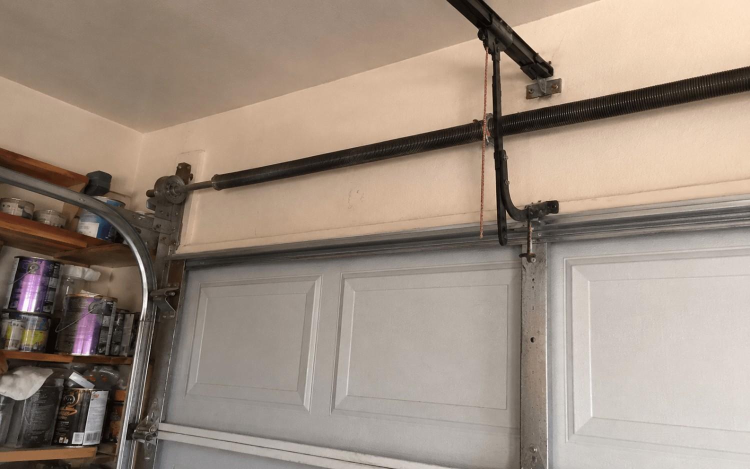The same garage door with a new torsion spring wound tight and balanced after a Boost Garage Doors spring repair.
